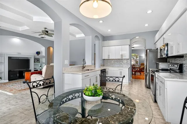 a bedroom with a bed a chair and a large window