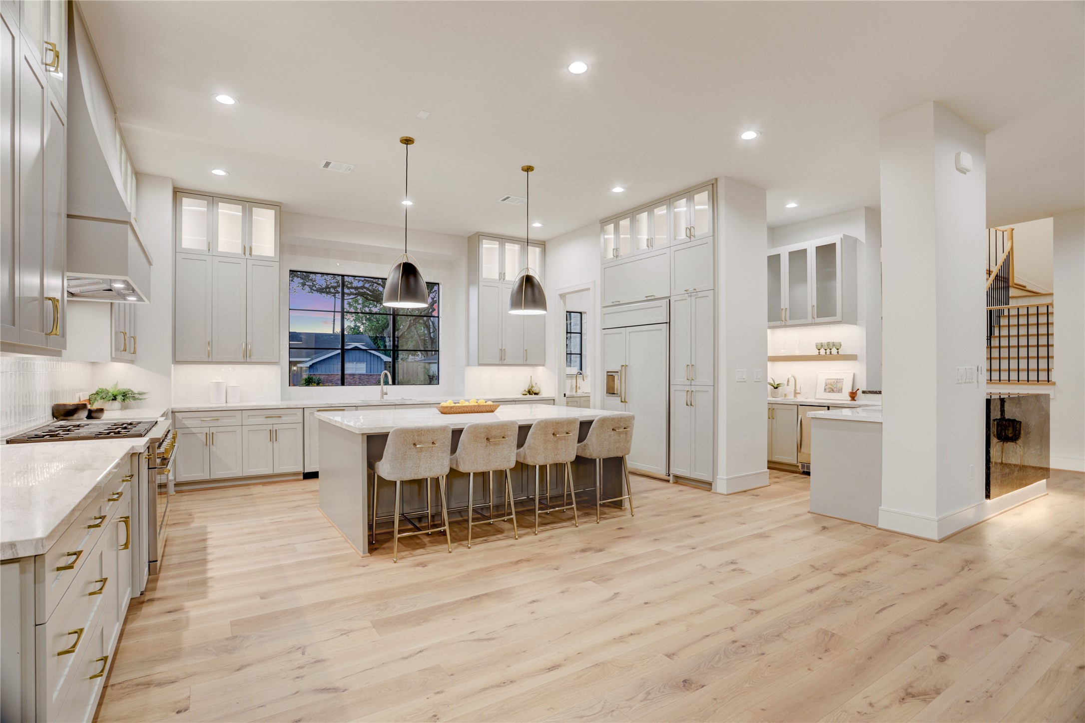 8935 Pado Street Houston, TX 77055 - Photo 14 of 50 a large kitchen with stainless steel appliances kitchen island granite countertop a large island a stove a refrigerator and a sink