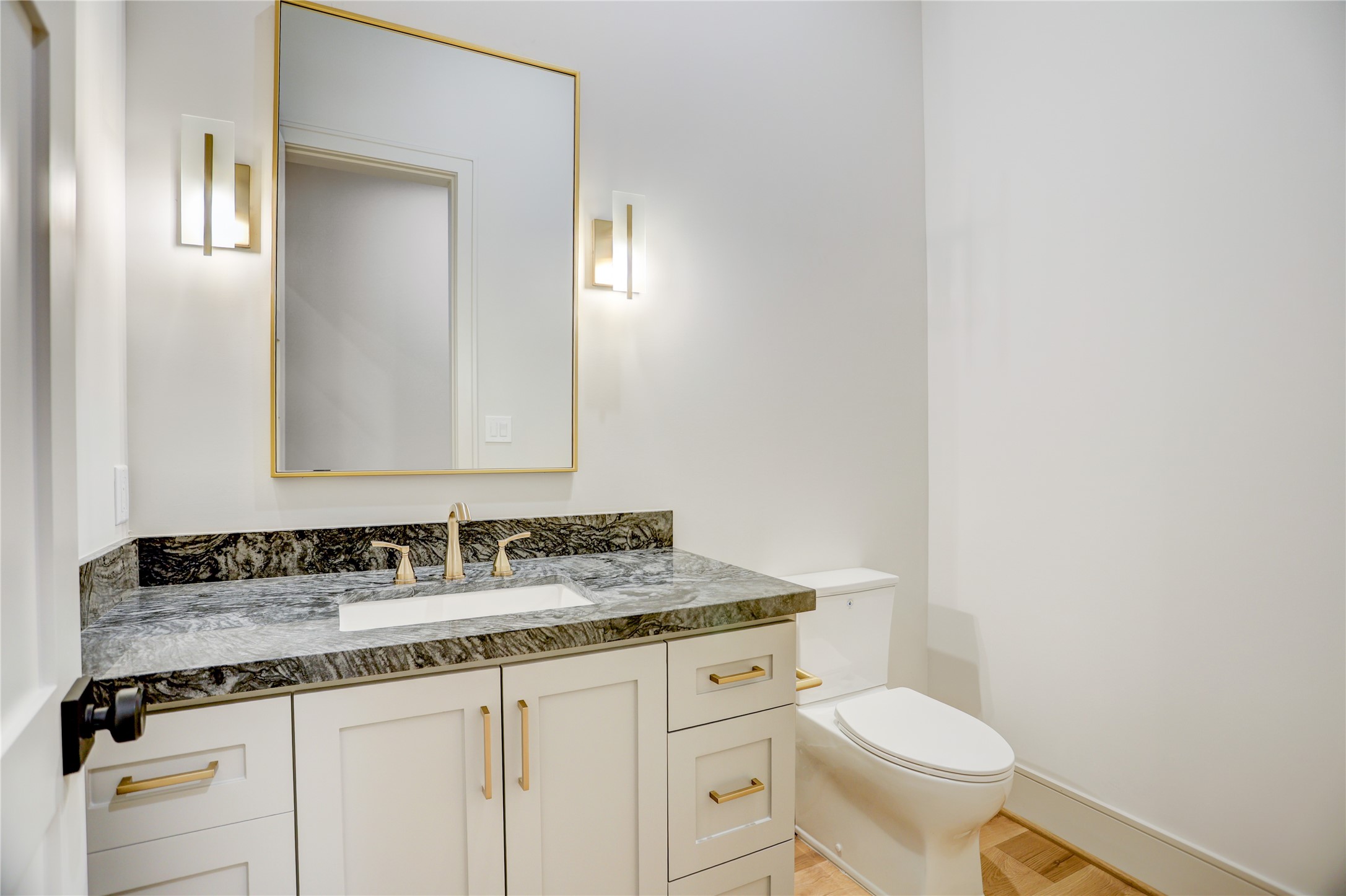 8935 Pado Street Houston, TX 77055 - Photo 27 of 50 a bathroom with a granite countertop toilet sink and mirror