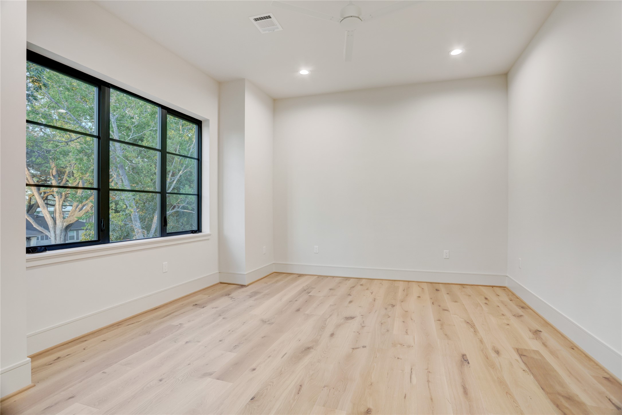 8935 Pado Street Houston, TX 77055 - Photo 35 of 50 a view of empty room with wooden floor and fan