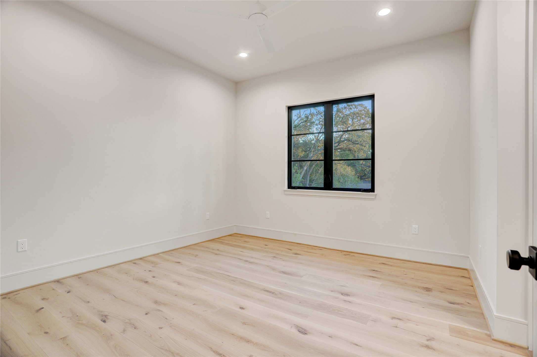 8935 Pado Street Houston, TX 77055 - Photo 39 of 50 a view of an empty room with wooden floor and a window