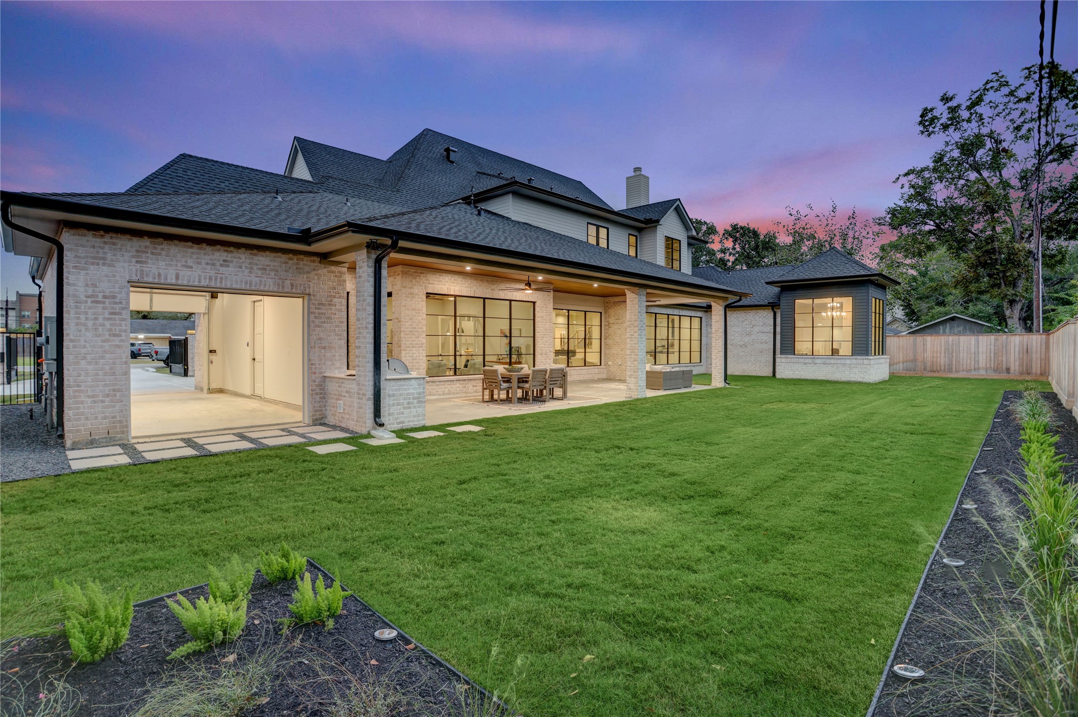8935 Pado Street Houston, TX 77055 - Photo 4 of 50 a front view of a house with a garden and yard