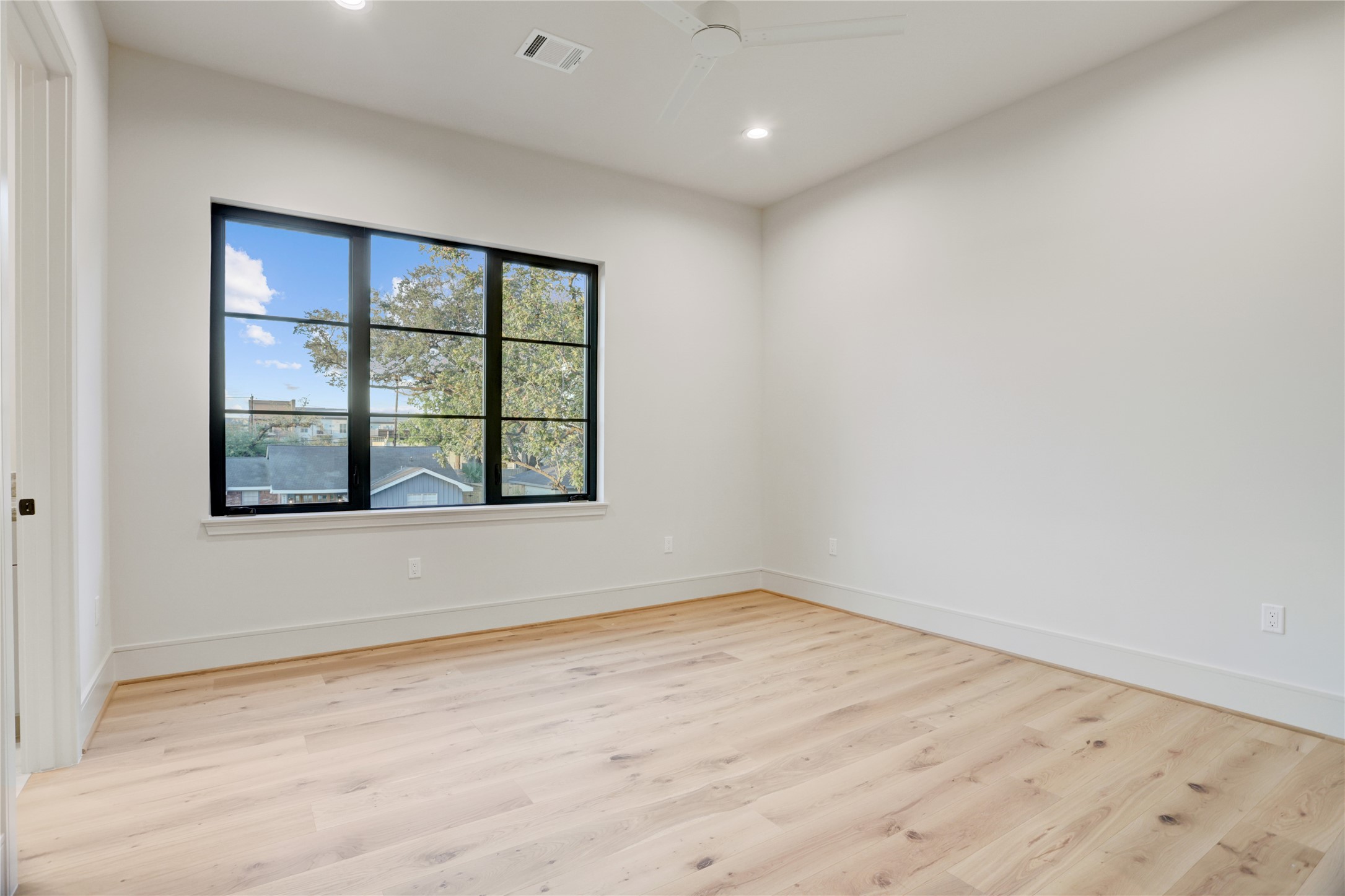 8935 Pado Street Houston, TX 77055 - Photo 43 of 50 an empty room with wooden floor and windows