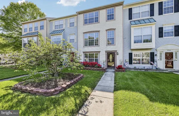 a front view of a residential apartment building with a yard