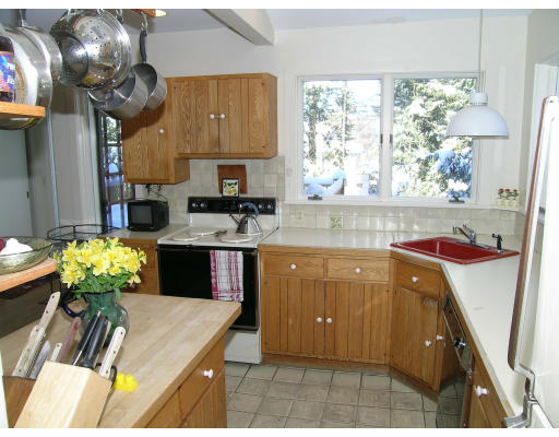175 Pine Ridge Road Newton, MA 02468 - Photo 10 of 18 a kitchen with stainless steel appliances granite countertop a sink counter space cabinetry a stove and a window