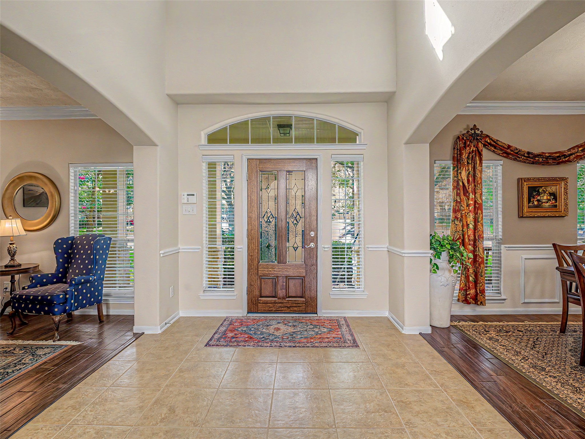 2210 Fox Path Katy, TX 77494 - Photo 6 of 47 The foyer opens up to a spectacular double-height ceiling, creating an immediate sense of grandeur and volume the moment you step through the front door. Large upper-level cutouts flood the main level with natural sunlight from above.