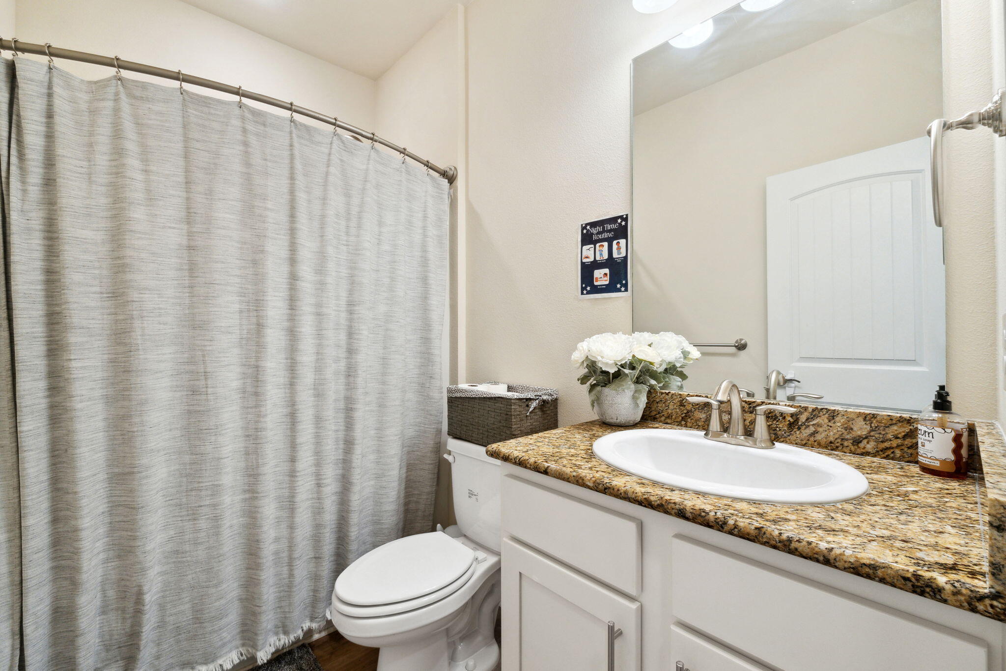 585 Riverwalk Circle Freeport, FL 32439 - Photo 15 of 36 a bathroom with a granite countertop sink and a mirror