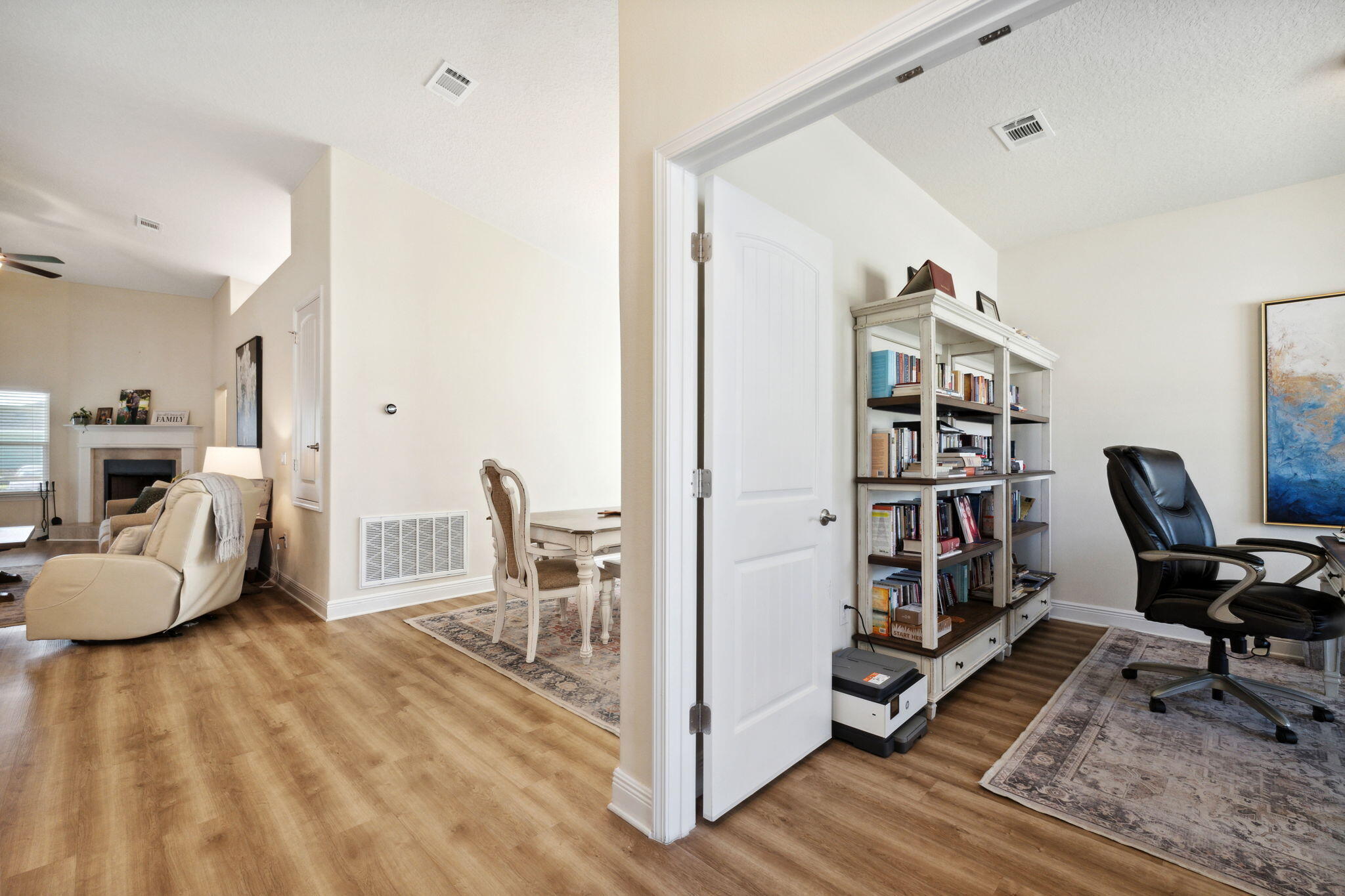 585 Riverwalk Circle Freeport, FL 32439 - Photo 18 of 36 a view of a workspace with furniture and a book shelf