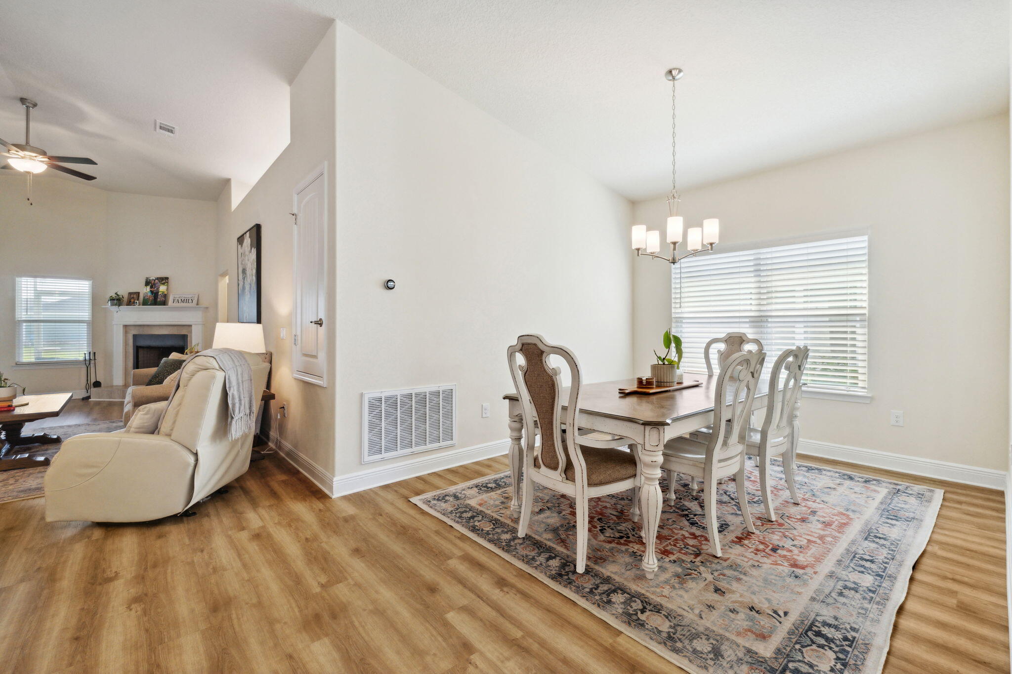 585 Riverwalk Circle Freeport, FL 32439 - Photo 19 of 36 a dining room with furniture a chandelier and wooden floor