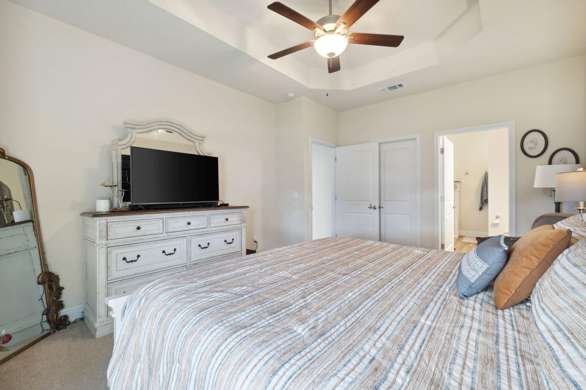585 Riverwalk Circle Freeport, FL 32439 - Photo 25 of 36 a bedroom with a bed and a flat tv screen on dresser