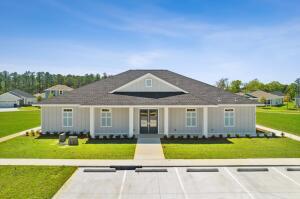 585 Riverwalk Circle Freeport, FL 32439 - Photo 32 of 36 a front view of a house with a yard