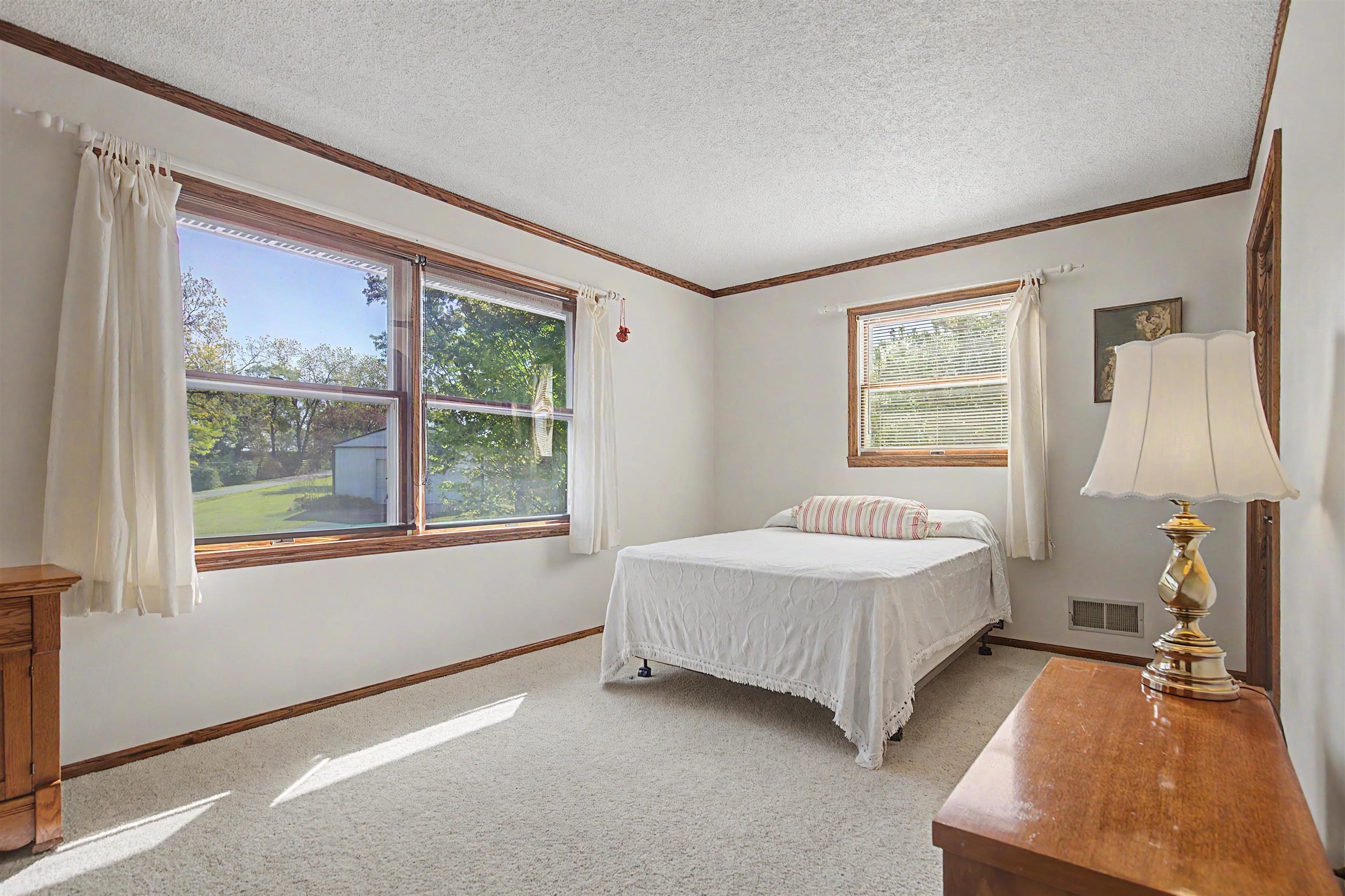17380 Corbett Road Mount Carroll, IL 61053 - Photo 16 of 65 a room with a bed and a window