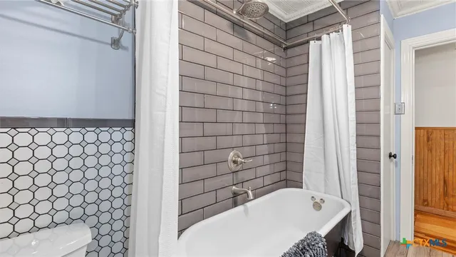 a bathroom with a bathtub and shower