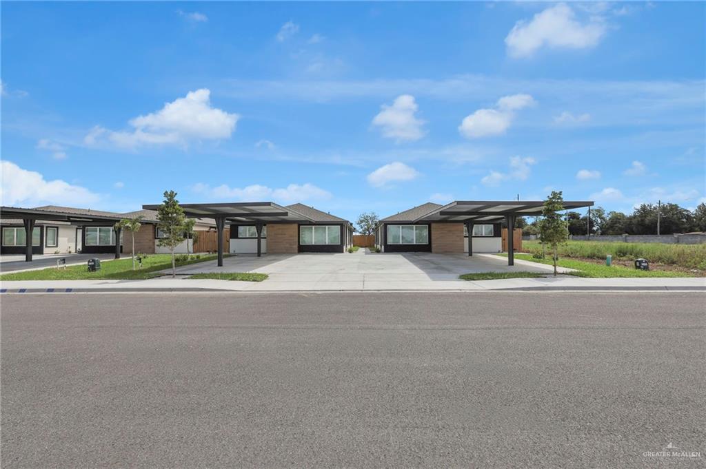1612 Shadow Creek, Unit 4 Weslaco, TX 78599 - Photo 1 of 14 a front view of a house with a yard and garage