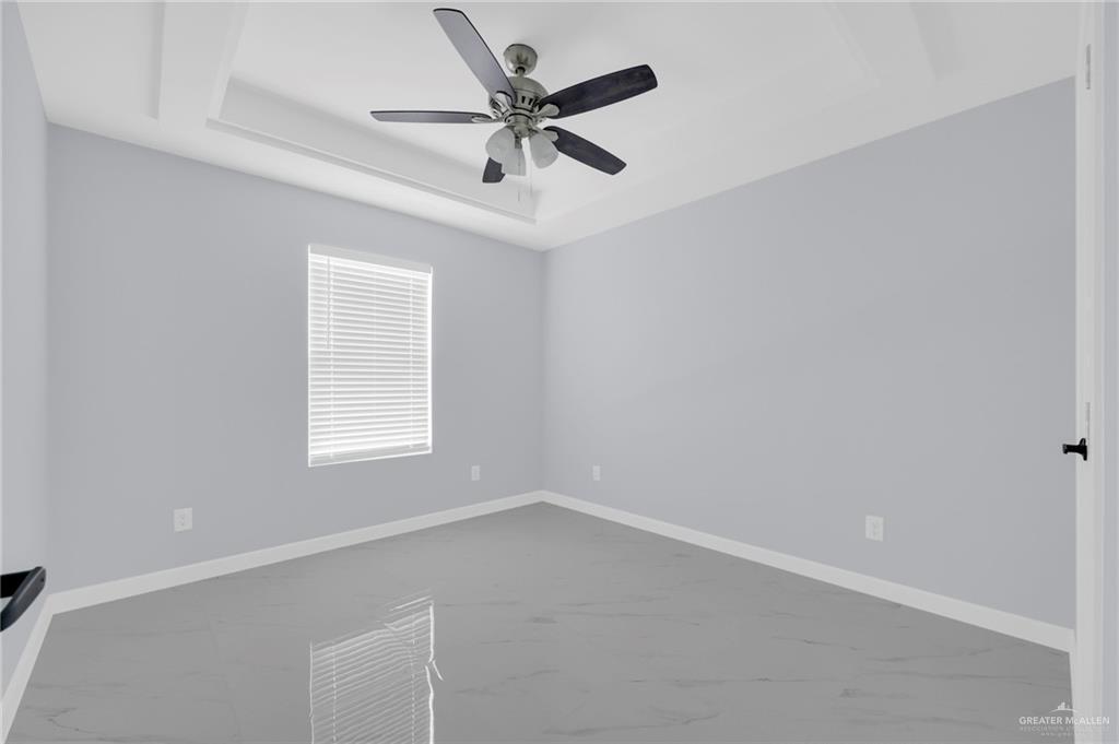 1612 Shadow Creek, Unit 4 Weslaco, TX 78599 - Photo 11 of 14 an empty room with a window and a fan