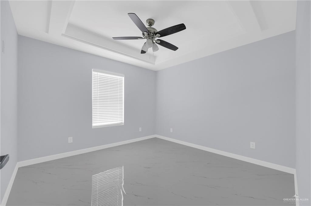 1612 Shadow Creek, Unit 4 Weslaco, TX 78599 - Photo 8 of 14 an empty room with a window and ceiling fan