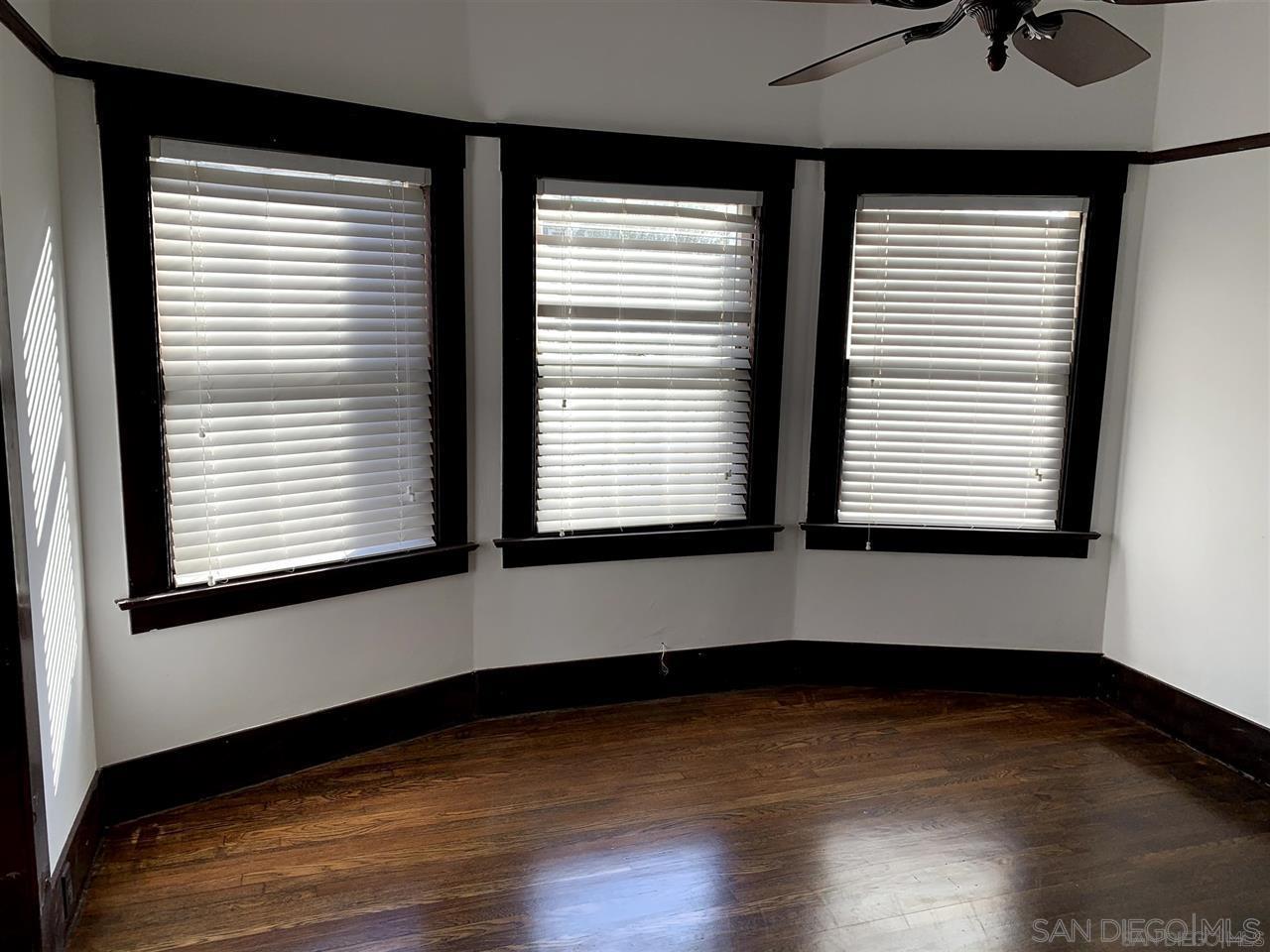 838 21st Street San Diego, CA 92102 - Photo 12 of 16 an empty room with wooden floor and windows