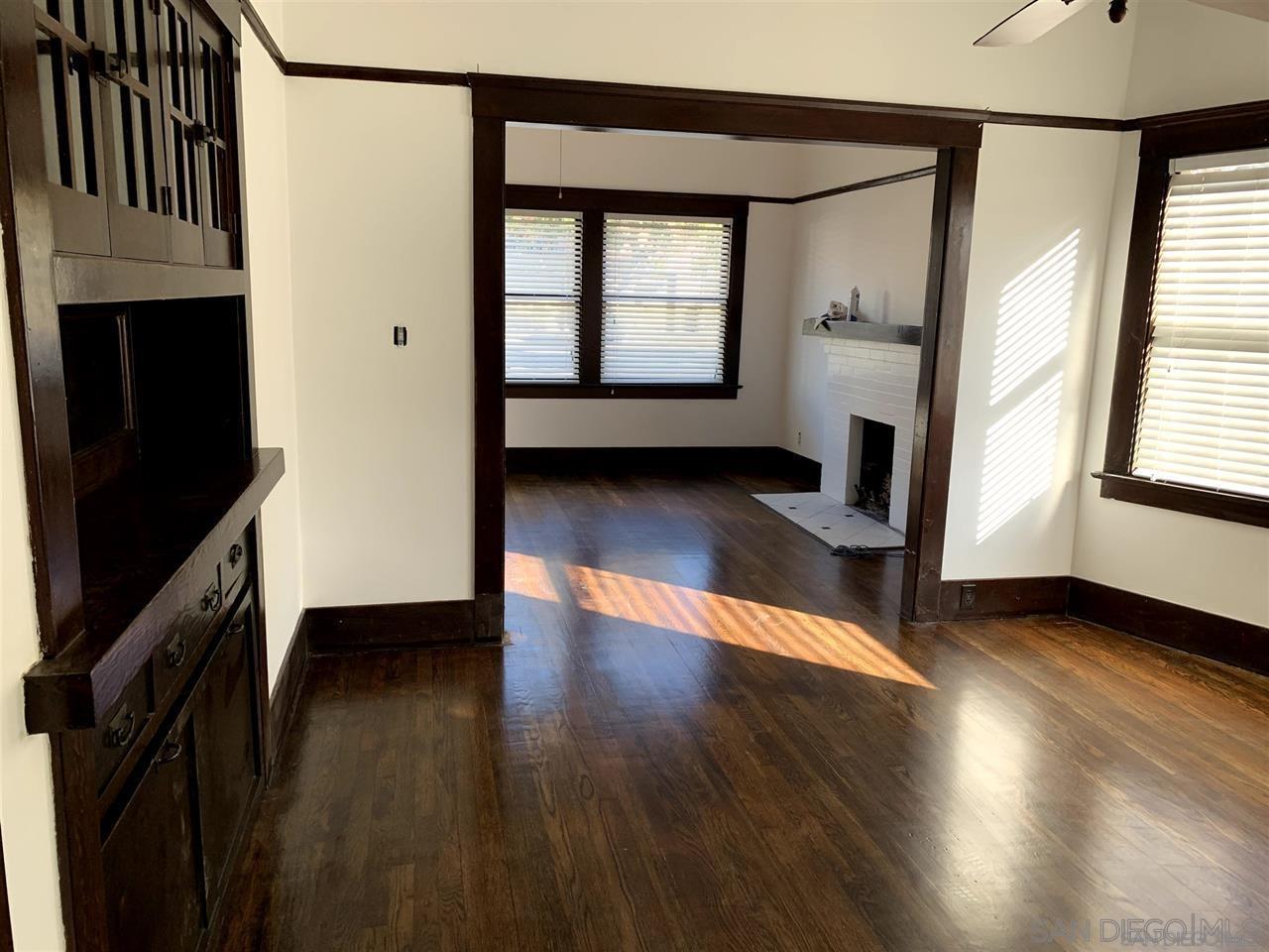 838 21st Street San Diego, CA 92102 - Photo 13 of 16 an empty room with wooden floor windows and a fireplace