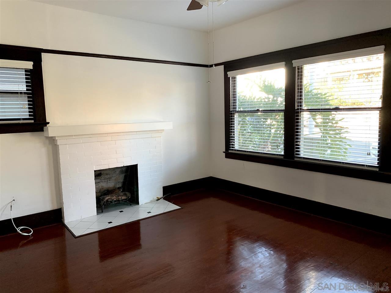 838 21st Street San Diego, CA 92102 - Photo 5 of 16 a living room with a fireplace and a floor to ceiling window