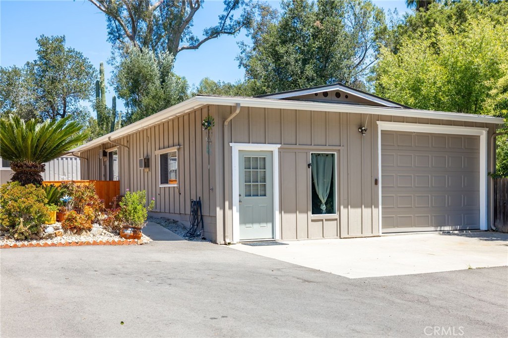 1256 East Fallbrook Street Fallbrook, CA 92028 - Photo 44 of 59 a front view of a house with a yard and garage