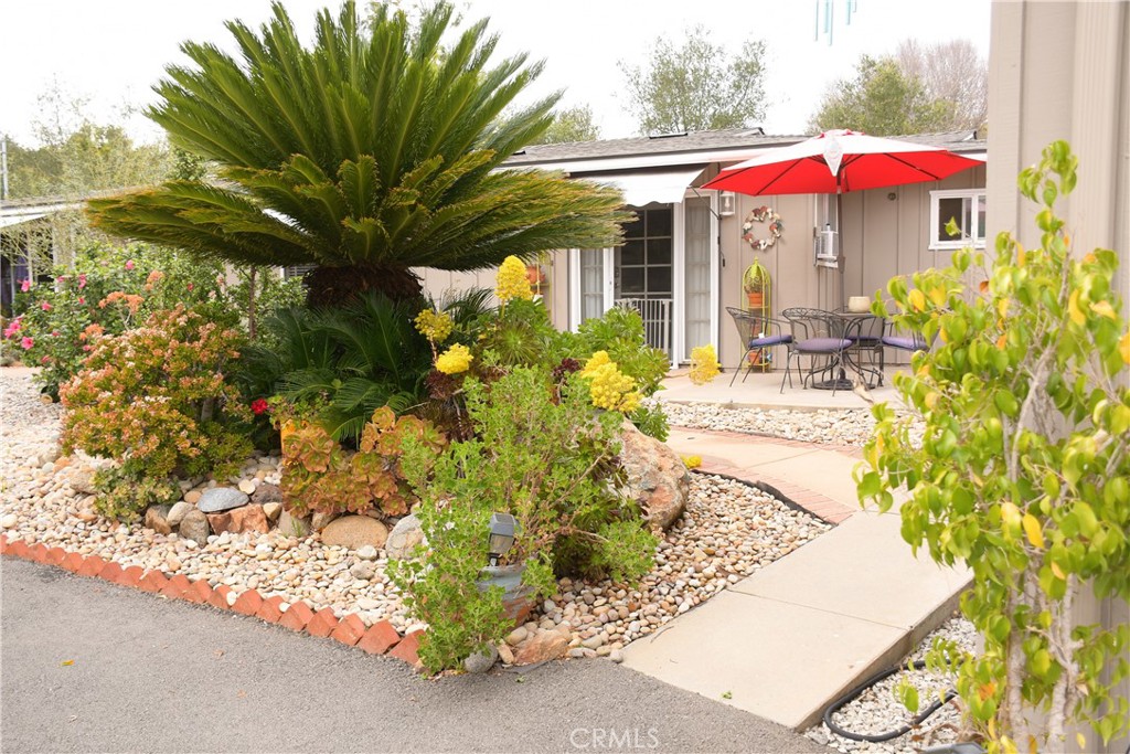 1256 East Fallbrook Street Fallbrook, CA 92028 - Photo 6 of 59 a view of a patio with table and chairs under an umbrella