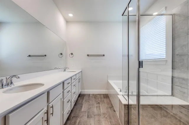 a bathroom with a bathtub and a shower