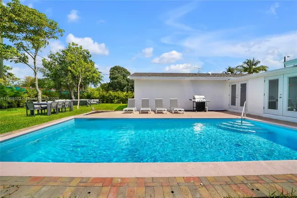 a view of a swimming pool with a yard