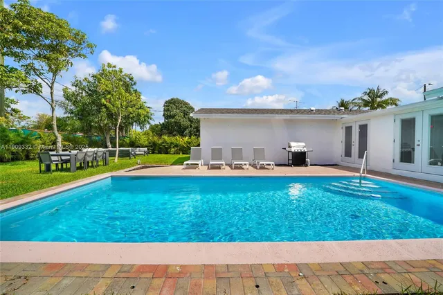 a view of a swimming pool with a yard