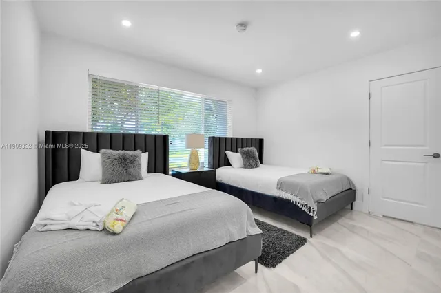 a bedroom with double bed and a large window