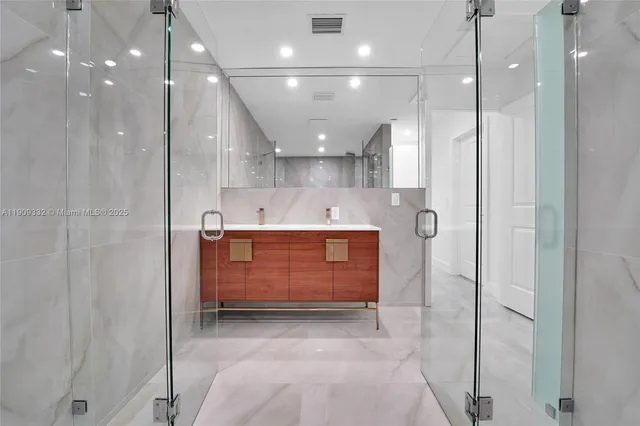 a bathroom with a sink toilet a mirror and shower