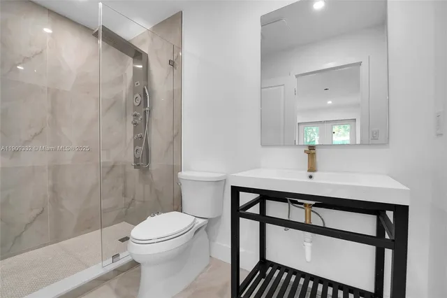 a bathroom with a sink toilet and shower