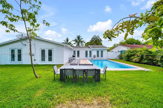 a view of a house with a backyard