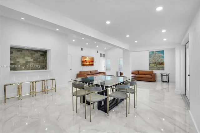 a large kitchen with lots of furniture a sink a table and chairs