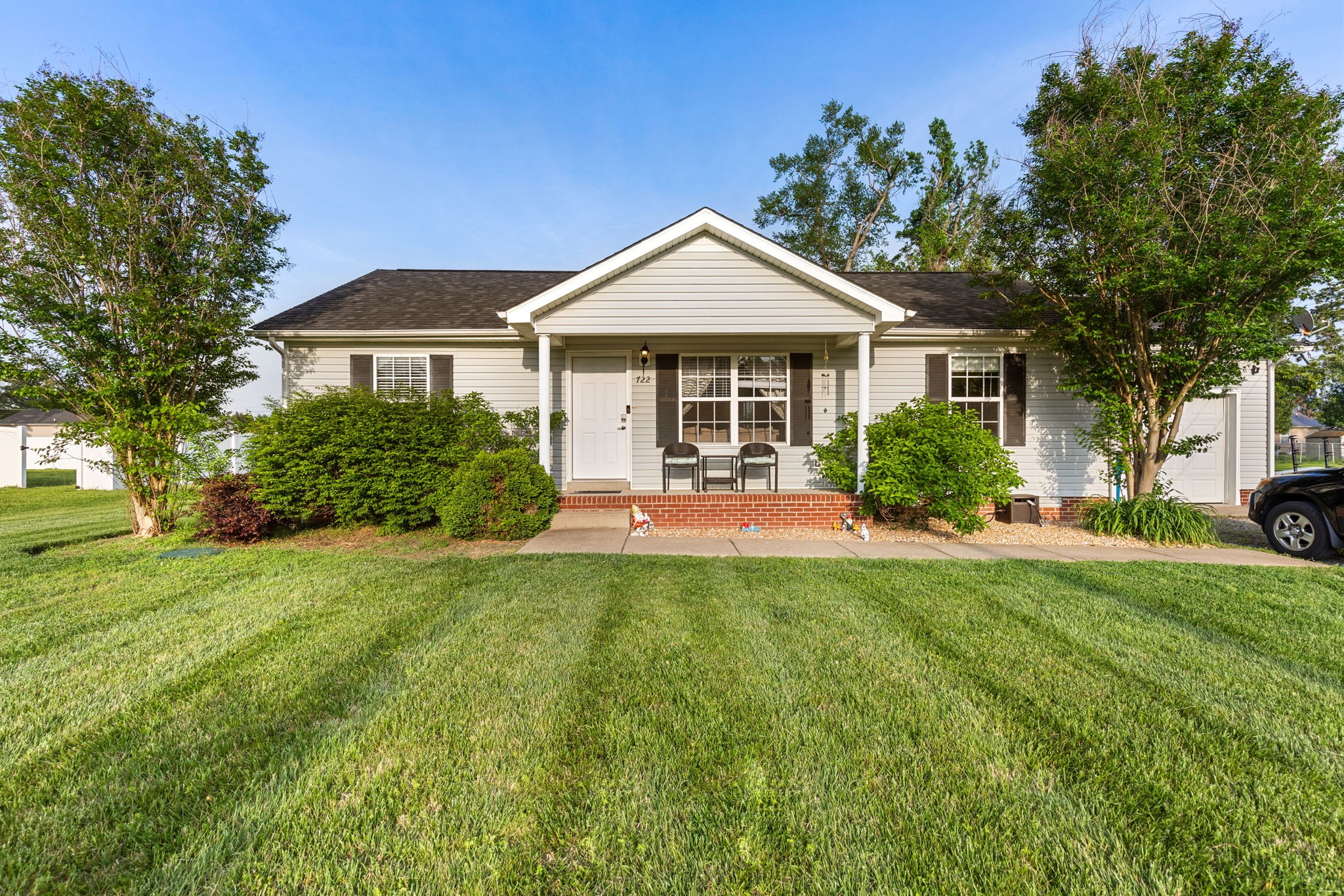 a front view of a house with yard and green space