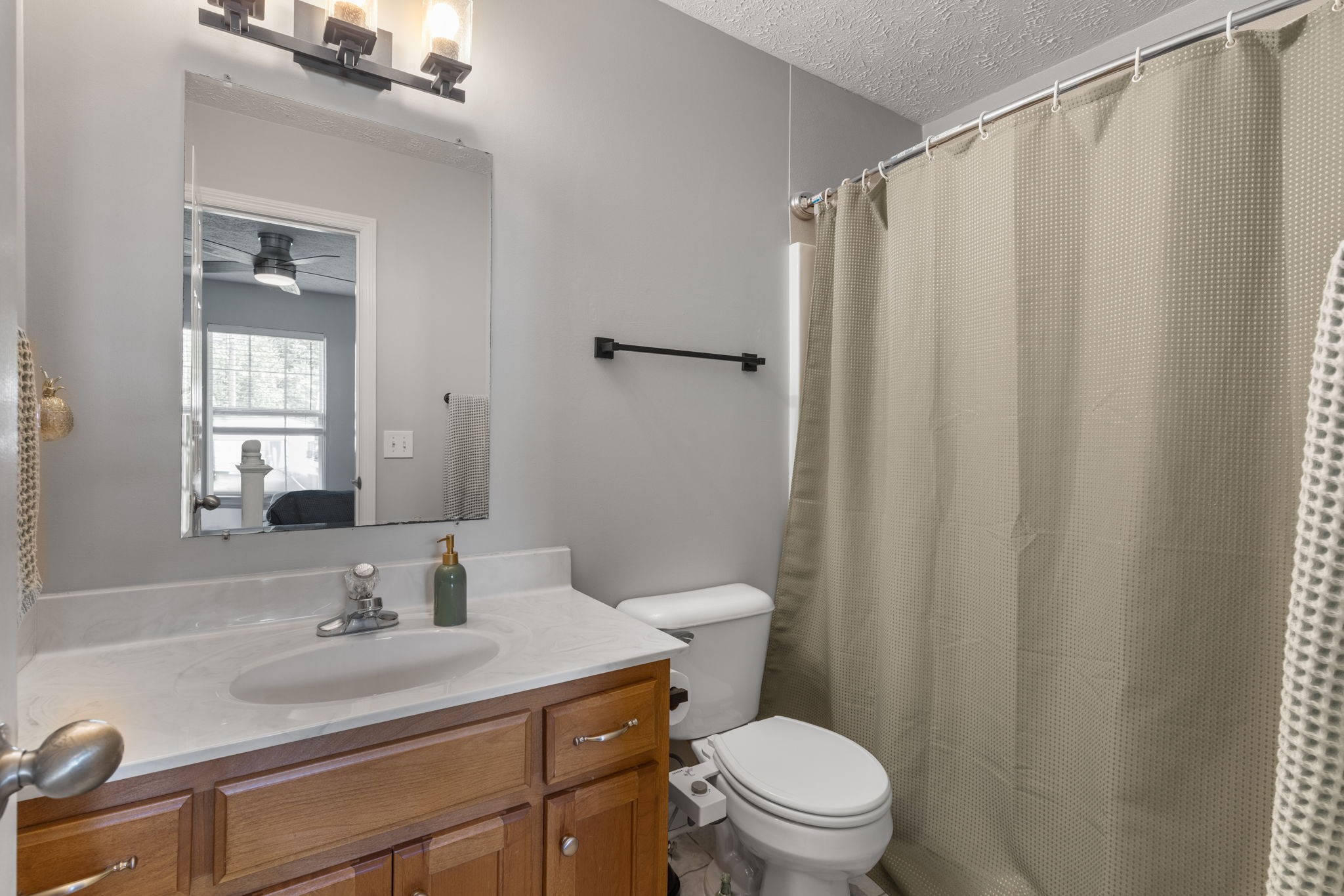 722 Eaglesham Drive Christiana, TN 37037 - Photo 15 of 29 a bathroom with a sink a toilet a mirror and shower curtain
