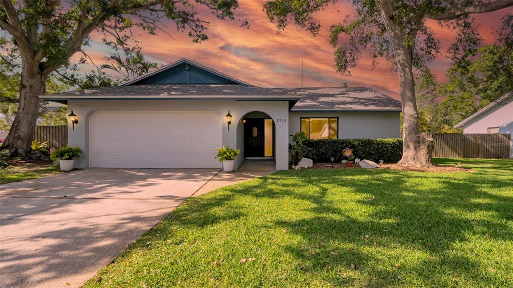 a front view of a house with a garden