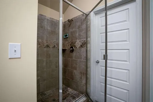 a bathroom with a double vanity sink a mirror and a shower