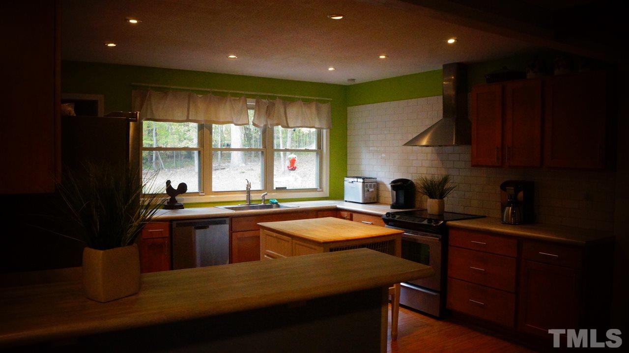 1030 Prologue Road Durham, NC 27712 - Photo 5 of 18 a kitchen with a sink stove and cabinets