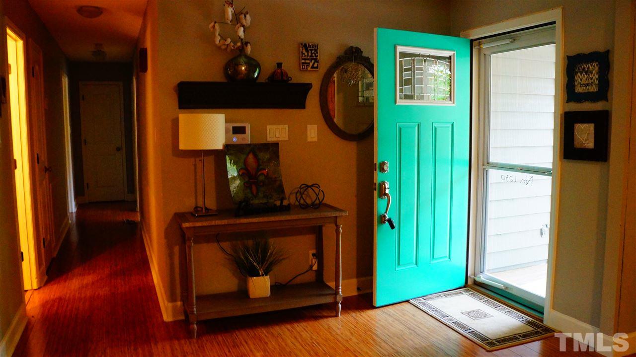 1030 Prologue Road Durham, NC 27712 - Photo 6 of 18 a view of hallway with mirror and a wooden floor