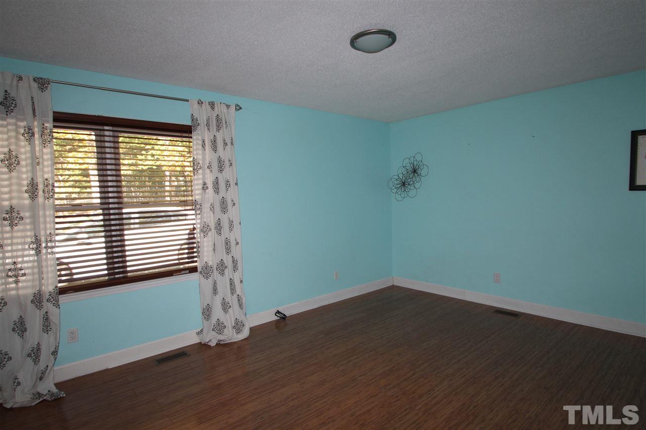 1030 Prologue Road Durham, NC 27712 - Photo 7 of 18 a view of a room with wooden floor and a window