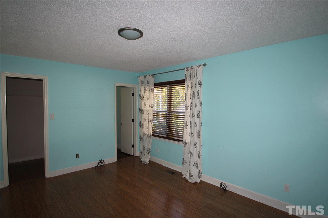 1030 Prologue Road Durham, NC 27712 - Photo 8 of 18 an empty room with wooden floor and windows