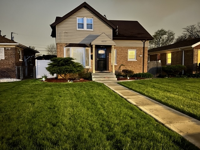 12240 South Racine Avenue Chicago, IL 60643 - Photo 1 of 14 a front view of a house with a yard