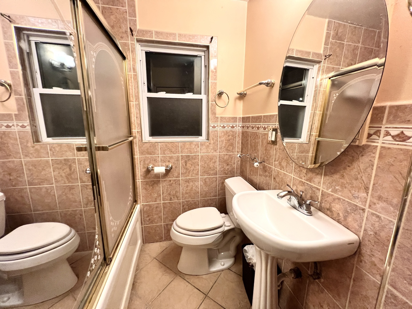 12240 South Racine Avenue Chicago, IL 60643 - Photo 11 of 14 a white toilet sitting next to a bathroom sink