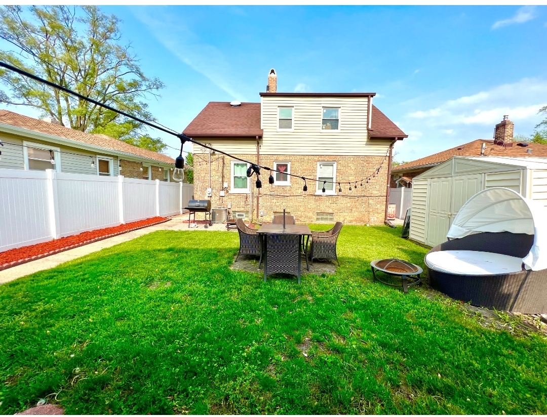 12240 South Racine Avenue Chicago, IL 60643 - Photo 12 of 14 a view of a chair and table in backyard of the house