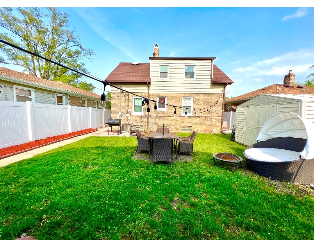 12240 South Racine Avenue Chicago, IL 60643 - Photo 14 of 14 a view of a chair and table in backyard of the house