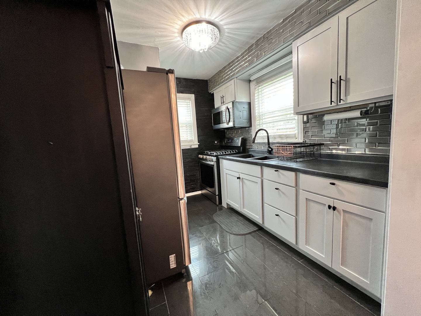 12240 South Racine Avenue Chicago, IL 60643 - Photo 2 of 14 a kitchen with granite countertop cabinets stainless steel appliances a sink and a window