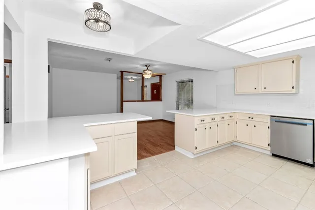 a kitchen with cabinets appliances and a counter space