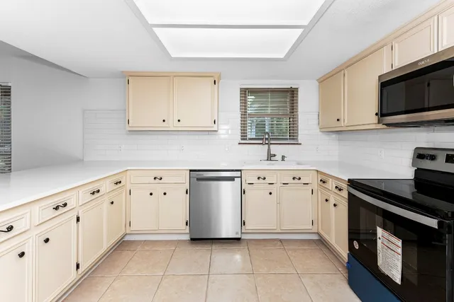 a view of empty room with wooden floor and fireplace