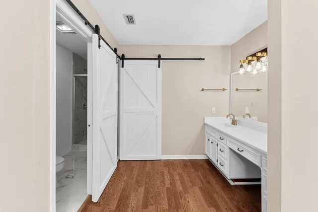 a bathroom with a sink mirror and a shower