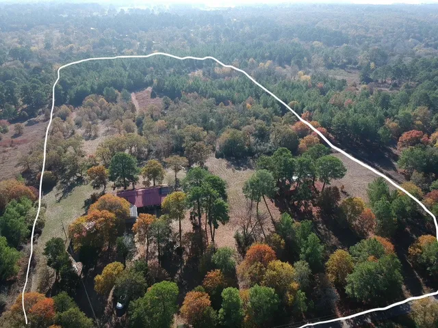 an aerial view of a house with a yard